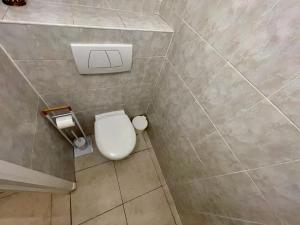 a bathroom with a white toilet in a room at Central Park Apartments by Connexion in Cannes