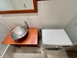 a small bathroom with a sink and a toilet at Central Park Apartments by Connexion in Cannes