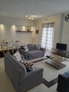 a living room with a couch and a table at chloi house in Kastoria