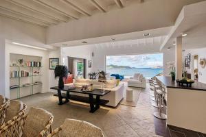 a living room with a couch and a table at Infiniti 1 BR Private Luxury Villa Breath Taking View in St Barth in Pointe Milou