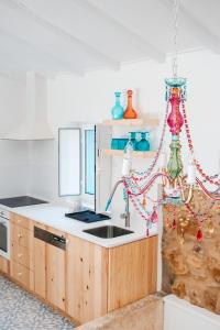 a kitchen with a sink and a kitchen with christmas decorations at Quinta das Alfazemas in Ericeira