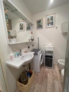 a bathroom with a sink and a washing machine at Casa Nicoli in Bergamo