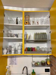 a kitchen cabinet filled with dishes and glasses at Casa Nicoli in Bergamo