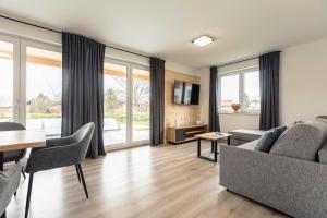 a living room with a couch and a table at Inzell Chalets by ALPS RESORTS in Inzell