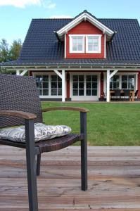 a chair on a deck in front of a house at Kleiner Onkel in Twist