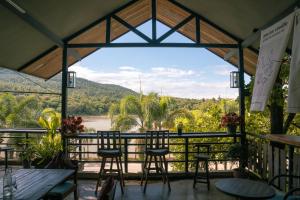 a view from the patio of a restaurant with tables and chairs at Kireethara Boutique Resort in Chiang Mai