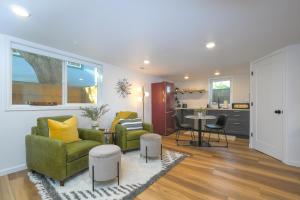 a living room with two chairs and a table at Bright & Modern Basement Apartment Dt N'hood in Vancouver