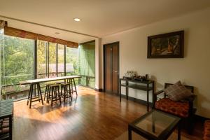 a living room with a table and chairs at Kireethara Boutique Resort in Chiang Mai