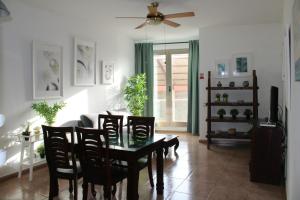 a living room with a table and chairs and a couch at Casa Bubal by Best Holidays Fuerteventura in Corralejo