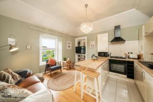 a kitchen and living room with a couch and a table at Riverview in Monifieth