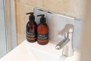 two bottles ofodorizers sitting on a bathroom sink at Riverview in Monifieth