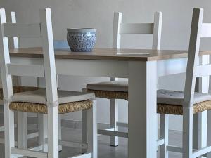 a table and chairs with a bowl on top of it at Lara's Apartment in Lido di Camaiore