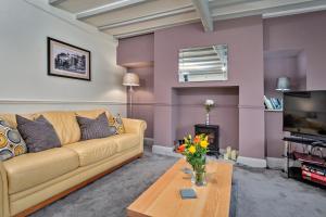 a living room with a couch and a tv at Finest Retreats - Cloggers Cottage in Darley