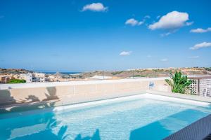 a swimming pool on the roof of a building at Townhouse17 Boutique Bed & Breakfast in Victoria