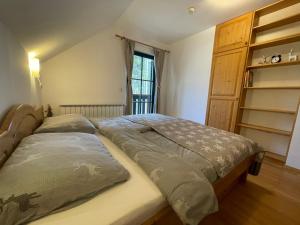 a bedroom with a bed and a book shelf at Chalet ANRA Pohorje in Zgornje Hoče