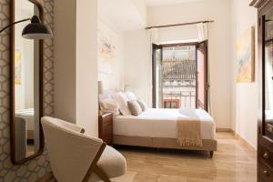 Posteľ alebo postele v izbe v ubytovaní Puerta Catedral Apartments