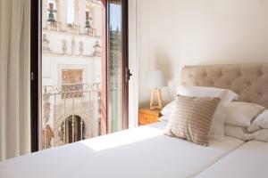 Posteľ alebo postele v izbe v ubytovaní Puerta Catedral Apartments