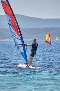 two people on the water with windsurfing at Guest House Marija in Bol