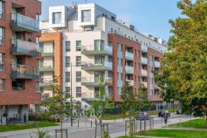 an apartment building in front of a street at Downtown Apartments Angielska Grobla - City Center & Parking in Gdańsk