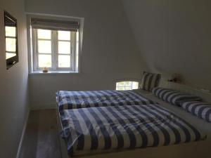 Uma cama ou camas num quarto em Traumhaftes Ferienhaus Reet gedeckt