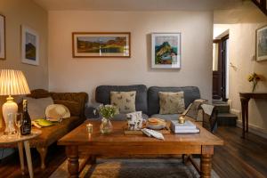 a living room with a couch and a table at Homely cottage with garden and mountain-view in Blaenau-Ffestiniog