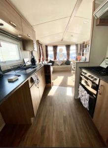 eine Küche und ein Wohnzimmer in einem Wohnwagen in der Unterkunft Swift Loire (Field view 78) in Jaywick Sands