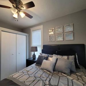 a bedroom with a bed with a ceiling fan at Retreat Suite 4 - Downtown Getaway in Grand Rapids