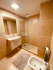 a bathroom with a sink and a shower at Tucuman Suite Bariloche in San Carlos de Bariloche