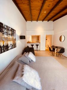 a bedroom with a large bed and a table at Tucuman Suite Bariloche in San Carlos de Bariloche