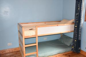 Comfortable countryside retreat for the family. في Kijabe: سرير بطابقين في غرفة ذات جدار أزرق