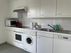 a kitchen with a sink and a washing machine at Ascona: San Materno-Mary in Ascona