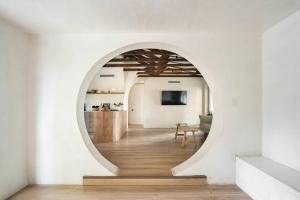 a hallway with an archway in a white room at Casa Terra Lumi - at lumicollection in Fort Lauderdale