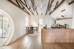 a kitchen with a counter and a table in a room at Casa Terra Lumi - at lumicollection in Fort Lauderdale