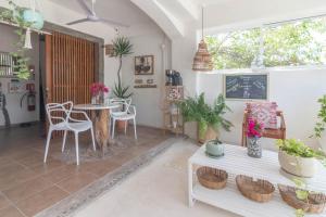 a living room with a table and chairs at Hotel Boutique Pachamama in Mahahual