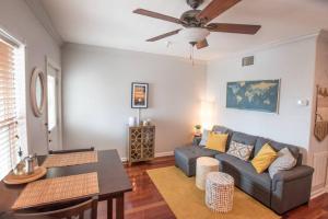 a living room with a couch and a ceiling fan at Sunshine-Shopping-Dining In the heart of Downtown in St. Petersburg