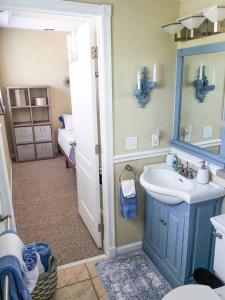 a bathroom with a blue sink and a mirror at RETRO RETREAT in DTSP - Explore the downtown area in St. Petersburg