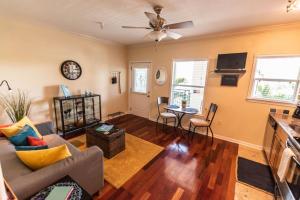 a living room with a couch and a table at Wine-Dine-Sunshine Cozy Flat in The Heart of DTSP in St Petersburg