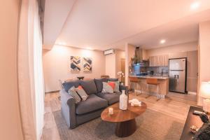 a living room with a couch and a table at Fully Serviced Apartment at Regatta Living - 2C in Santo Domingo