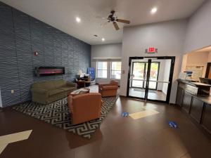 a living room with a couch and chairs and a fireplace at Quality Inn & Suites in Rosemount