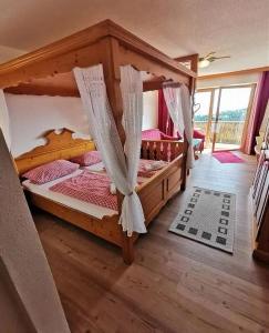 a bedroom with two bunk beds with mosquito nets at Romantik Appartements in Sankt Englmar