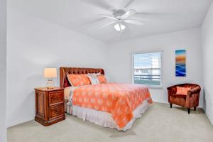 a bedroom with a bed and a ceiling fan at Oceanwalk Suite in New Smyrna Beach