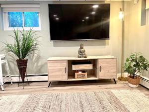 a living room with a tv on a wall at Immaculate Newly Renovated 1 Bedroom Apt Near NYC in Bergenfield