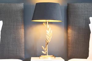 a lamp with a black shade on a table at Duplex 2 Bedroom Apartment - Close to City Centre - Balcony, Free Parking, Fast Wifi & Smart TVs by Yoko Property in Milton Keynes