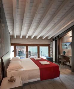 1 dormitorio con cama grande y ventana grande en Monte Isola - Decio Rooms en Monte Isola