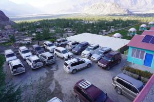 an aerial view of cars parked in a parking lot at Hotel Mountain Lodge Skardu in Skardu