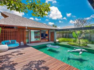 a swimming pool in the backyard of a house at The Santai by LifestyleRetreats in Canggu