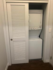 a small white refrigerator with its door open at Cossy room close to lake in chicago in Chicago
