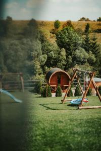 a playground with a swing set and a cabin at Jeleni Jar Apartamenty in Duszniki Zdrój