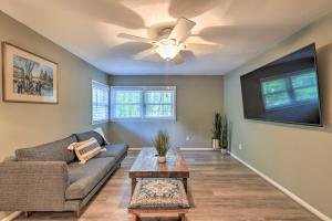 a living room with a couch and a ceiling fan at Sky Terrace Modern Apartment in Jonesboro! in Jonesboro