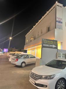 a parking lot with cars parked in front of a building at سما2 in Yanbu